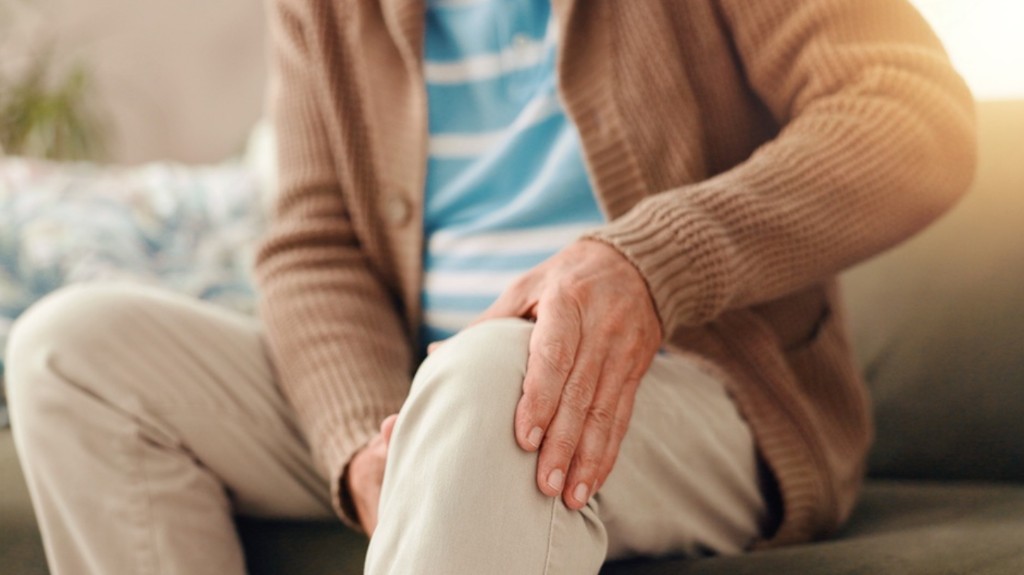 Person holding their knee in discomfort